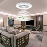 Modern living room with a ceiling fan and decorative elements.